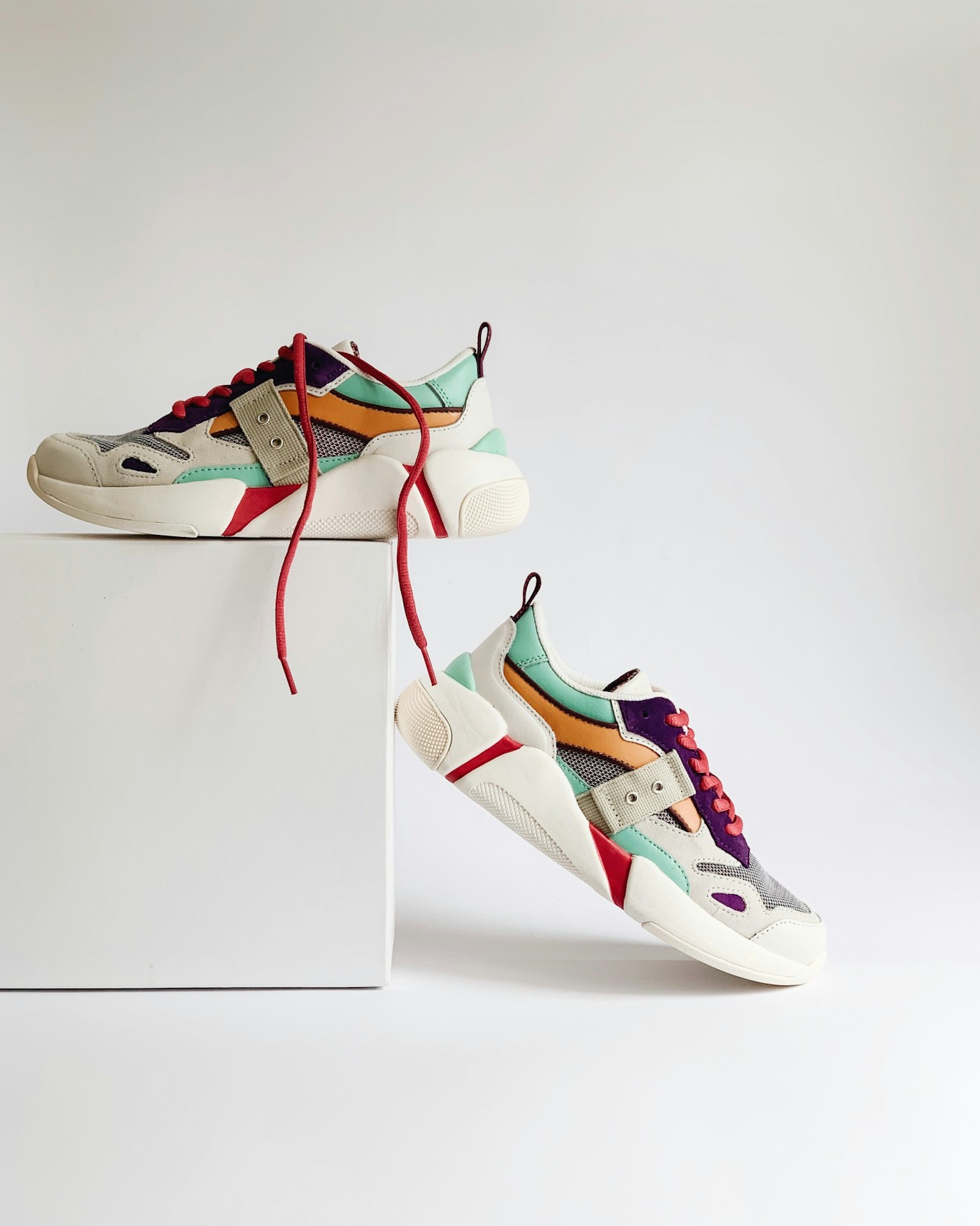 Colourful sneakers displayed on a shoe box